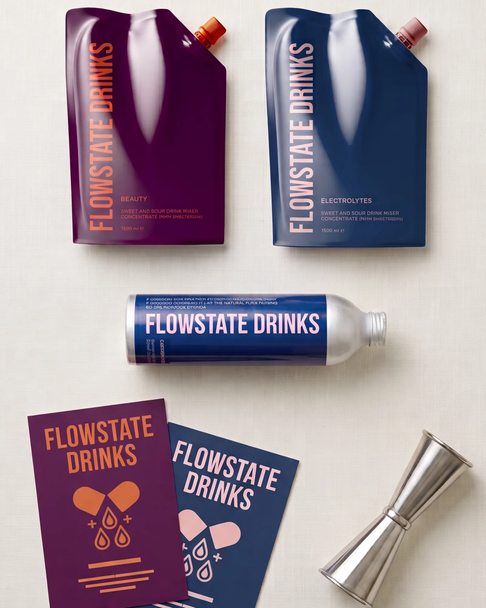 Tasting kit flat-lay: Beauty and Electrolytes pouches, aluminium bottle, A5 cards and a jigger